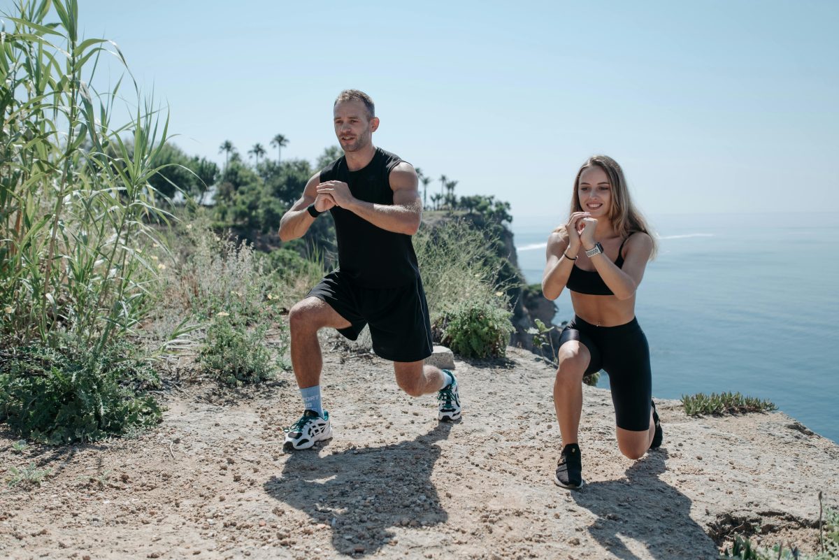 A Man and Woman Working Out Near the Cliff