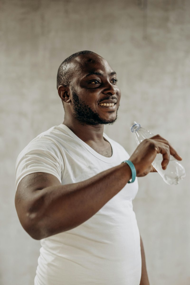 A Man drinking Water from a Bottle