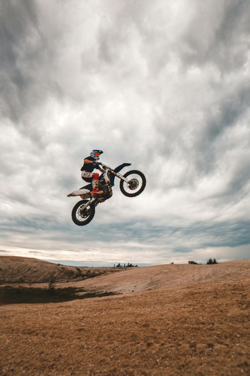 sportsman riding bike behind unrecognizable rivals during competition